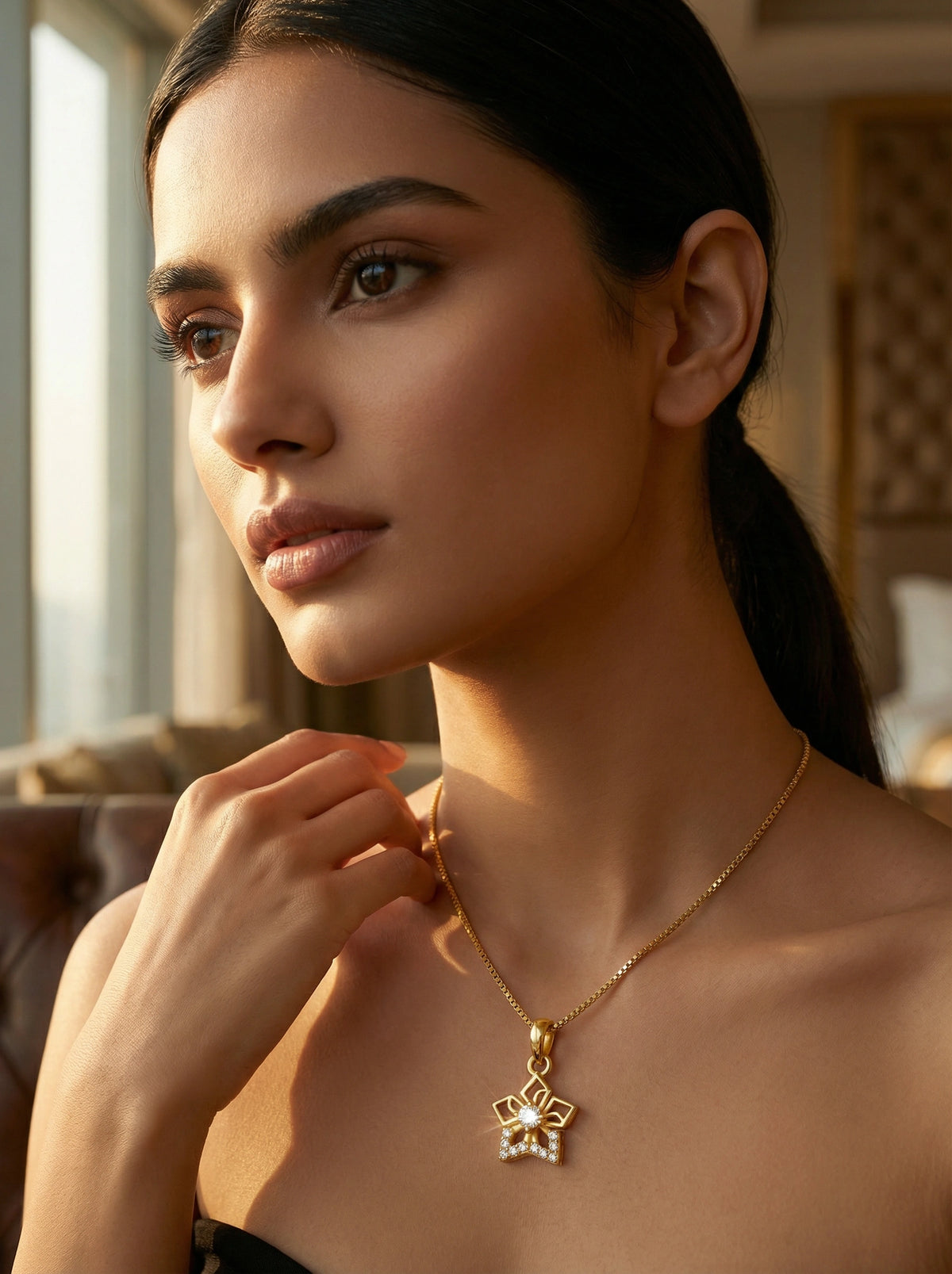 woman wearing a 18k gold plated necklace with a pendant indoors