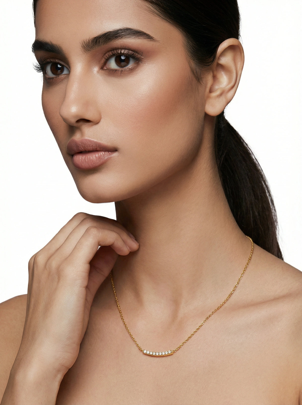 woman wearing a 18k gold plated necklace on a white background