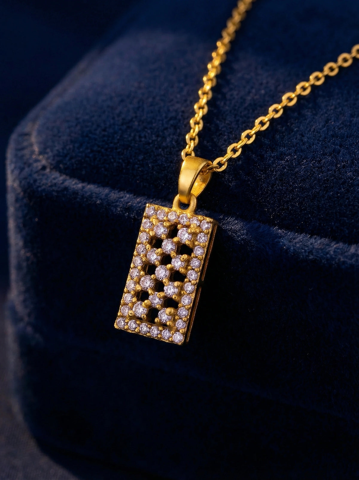 18k gold plated necklace with a rectangular pendant on a dark blue background