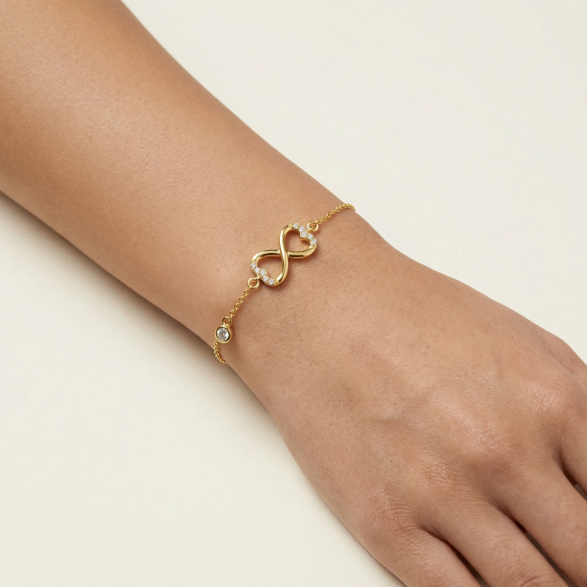 18k gold plated bracelet with a unique design on a wrist against a neutral background