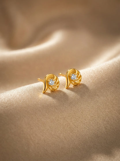 18k Gold plated earrings with diamond accents on a beige fabric background